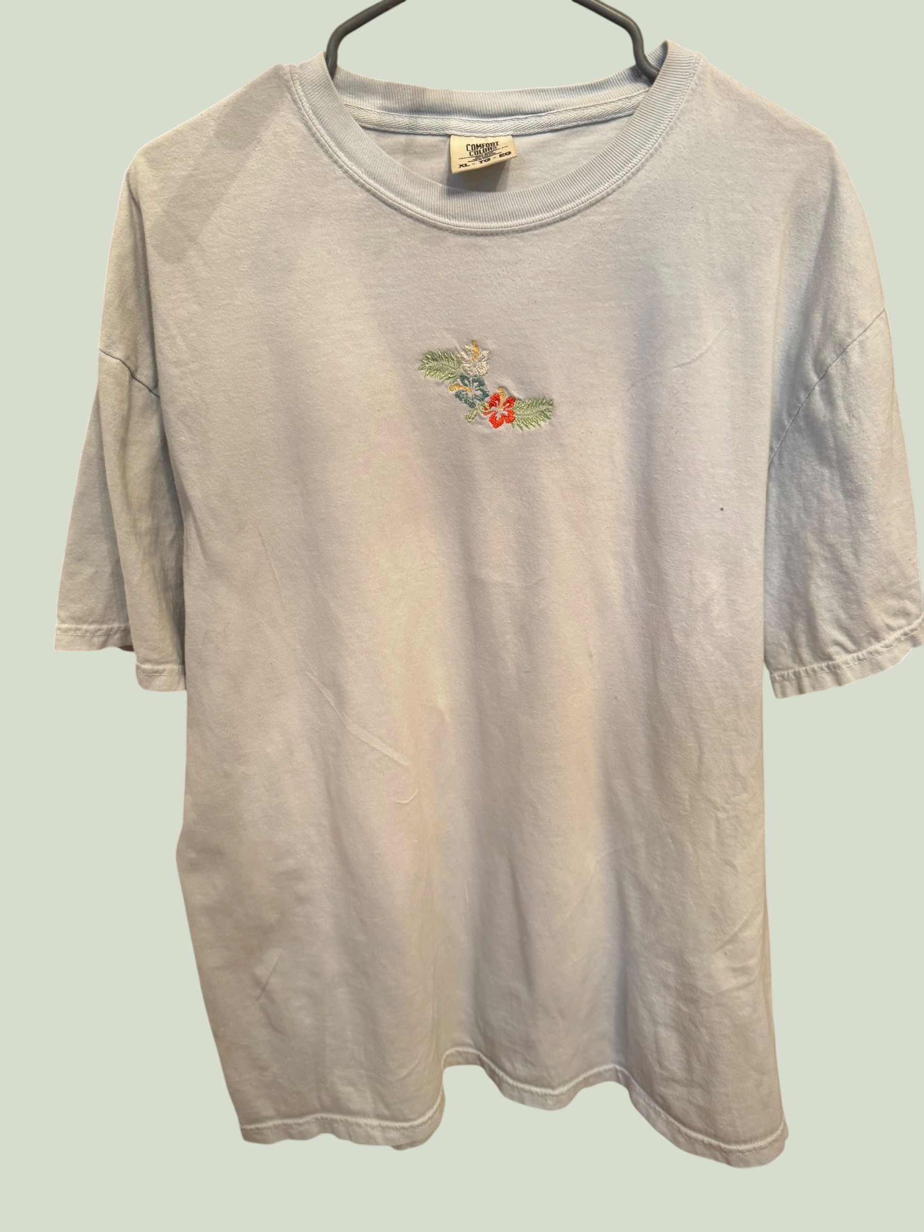 Light blue Comfort Colors tee with minimal hibiscus embroidery, multiple angles