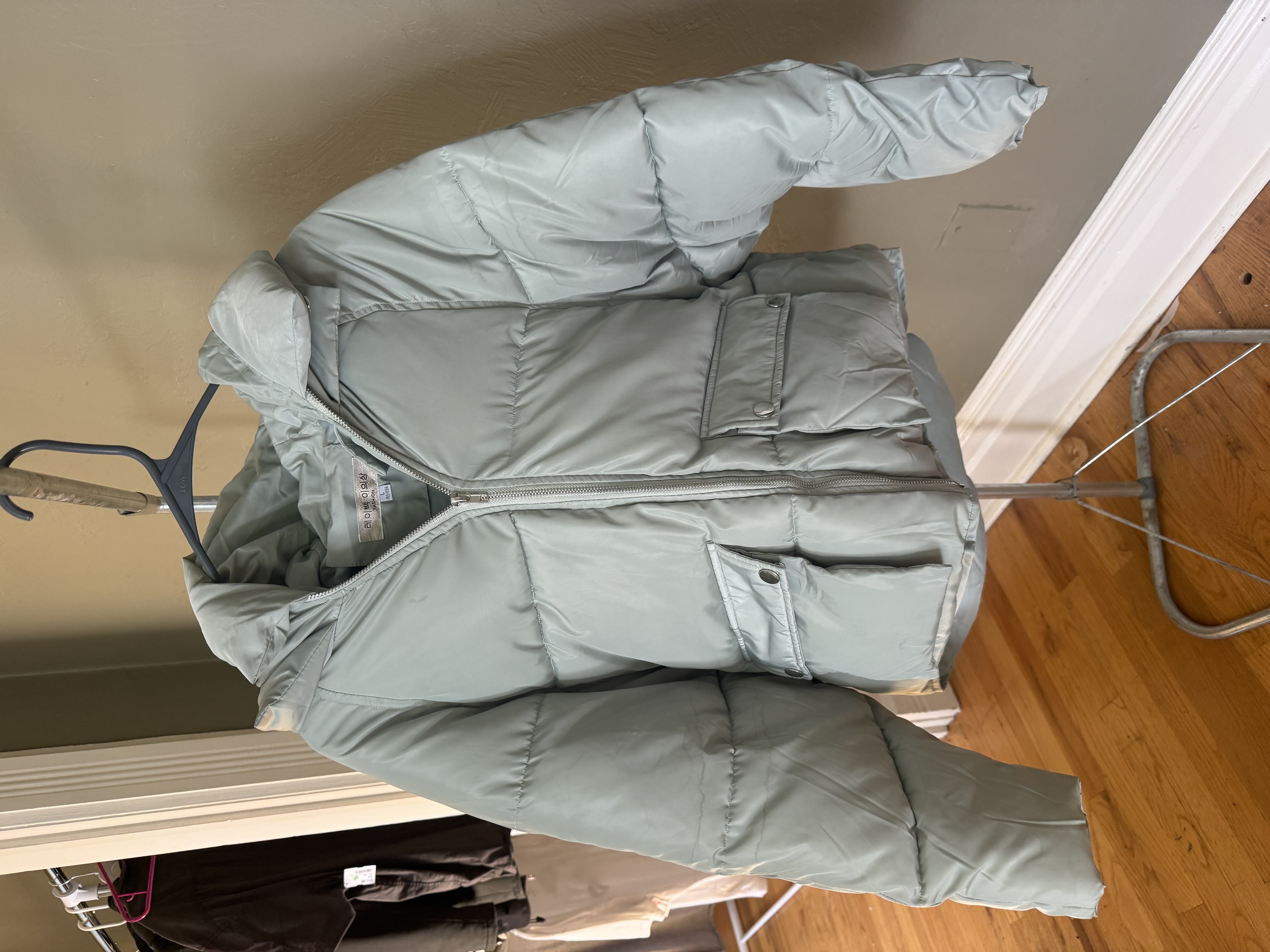 Light blue hooded puffer jacket, back and front views with interior brand tag